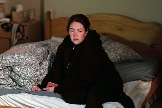 Stacey sitting on her bed in EastEnders