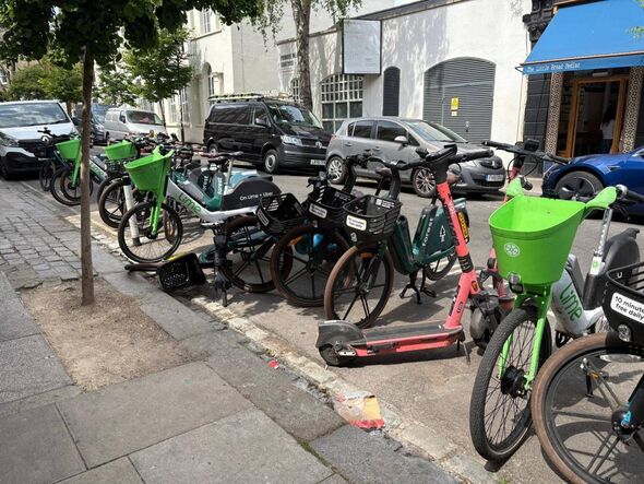 E-bikes and scooters flood the pavement outside the restaurant