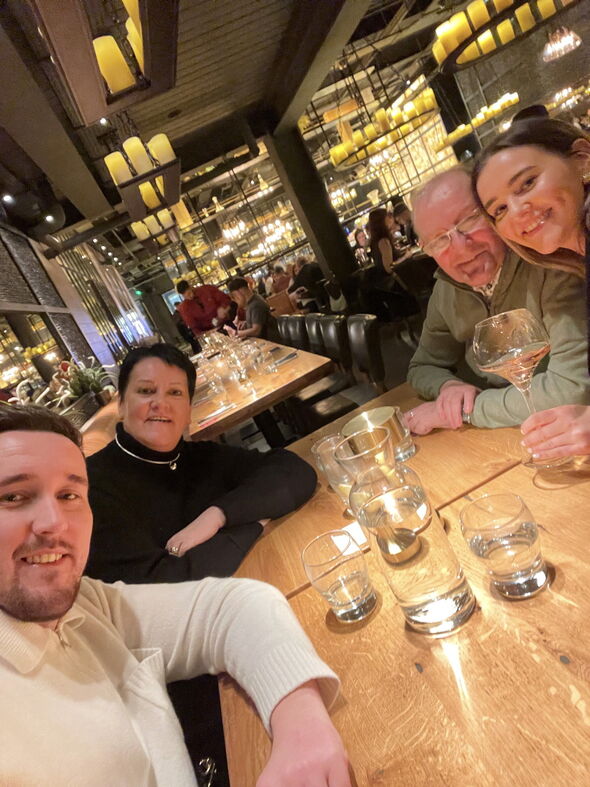 family smiling in restaurant
