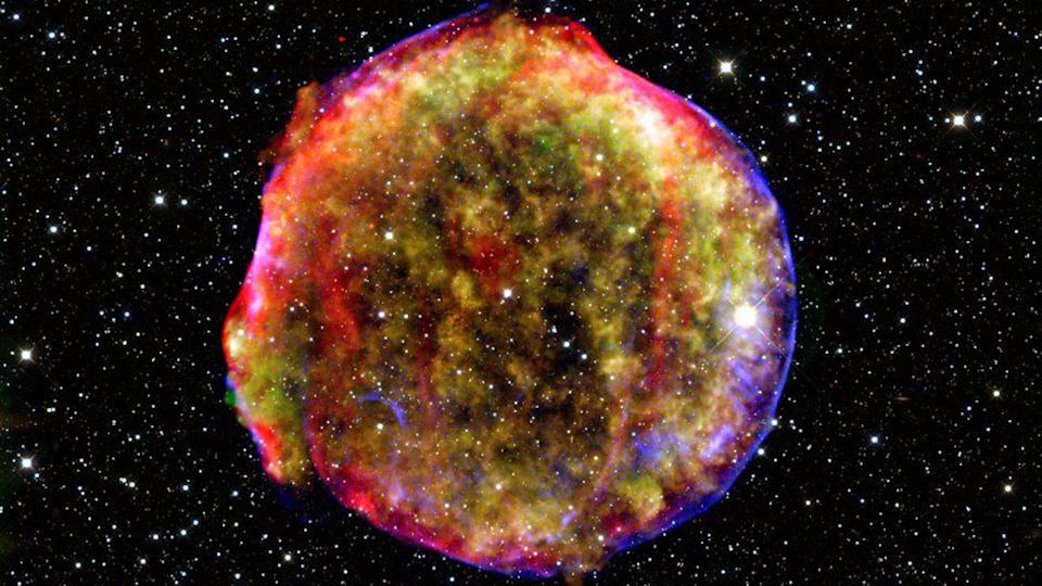  An image of a rainbow-colored circular cloud with sparkling stars behind it. 