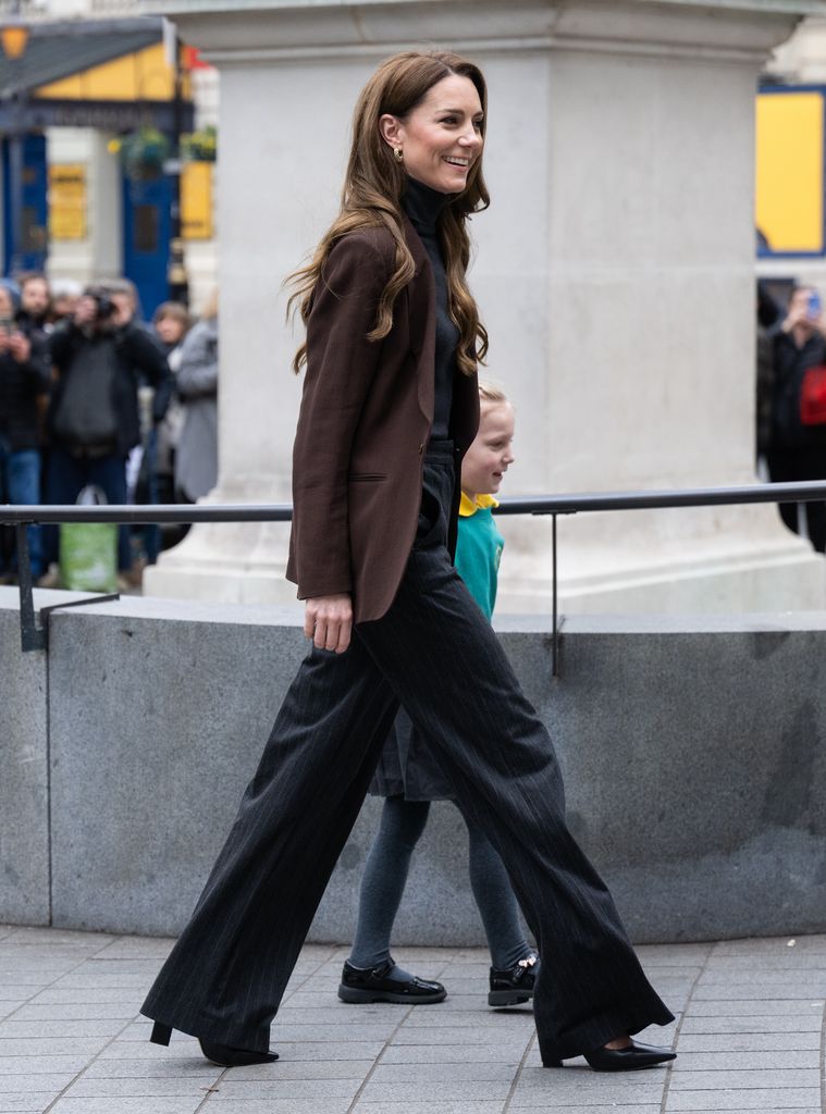 Catherine, Princess of Wales side on walking beside child