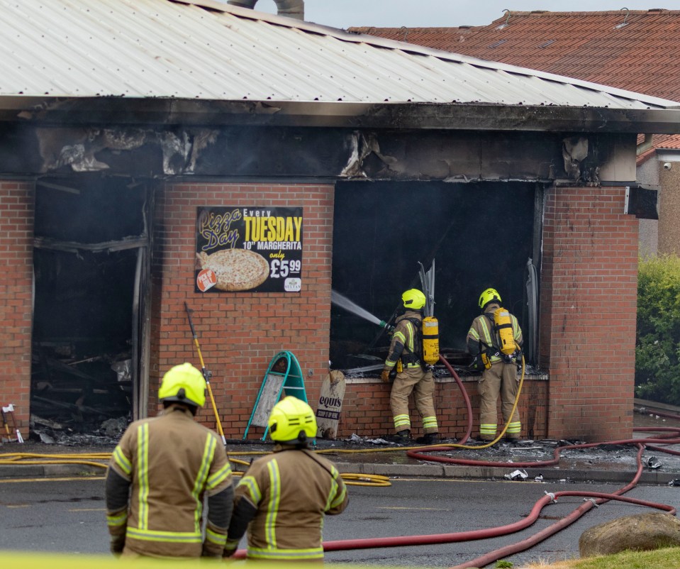 Firefighters extinguishing a fire at a chip shop.