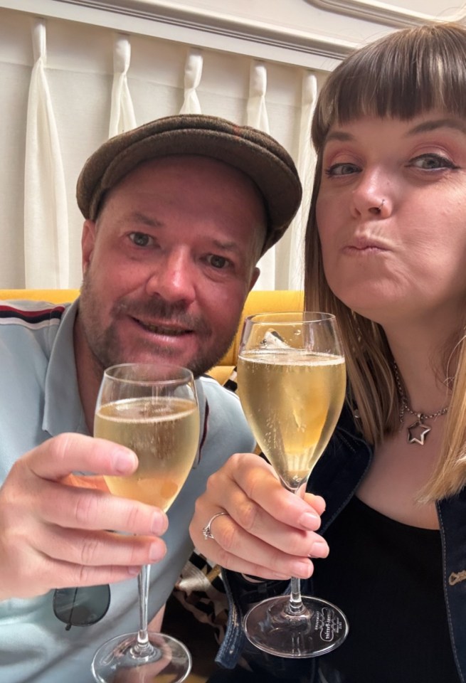 Couple toasting with champagne flutes.