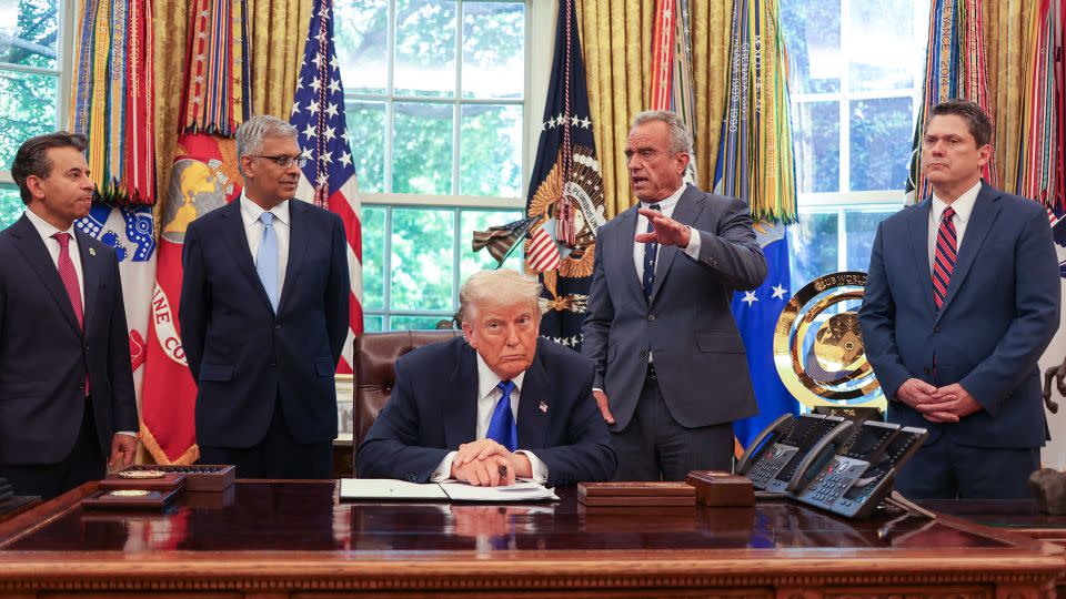 US Secretary of Health and Human Services Robert F. Kennedy Jr. speaks alongside Food and Drug Administration Commissioner Martin Makary, Director of the National Institutes of Health Jayanta Bhattachary, President Donald Trump, and speechwriter and political advisor Vince Haley during an executive orders signing event in the Oval Office of the White House in Washington, DC, on May 5. - Alex Wroblewski/AFP/Getty Images