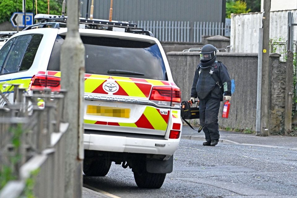 An army bomb disposal officer leaves at block of flats at the centre of a security alert in Newtownards. Photo: Alan Lewis