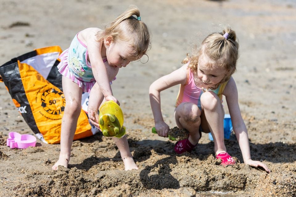 Erin (6) and her sister Alannah (3) enjoying the sunny weather at Helen's Bay beach on May 11, 2025 (Luke Jervis/Belfast Telegraph)