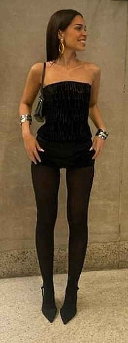 Jackie opted for a tiny strapless dress with black tights as she styled a similar ensemble