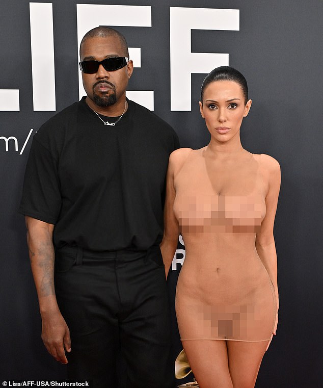 Kanye and his wife Bianca Censori sparked worldwide outrage at the Grammy's when she arrived in a completely see-through nude mesh dress worn without underwear (pictured)