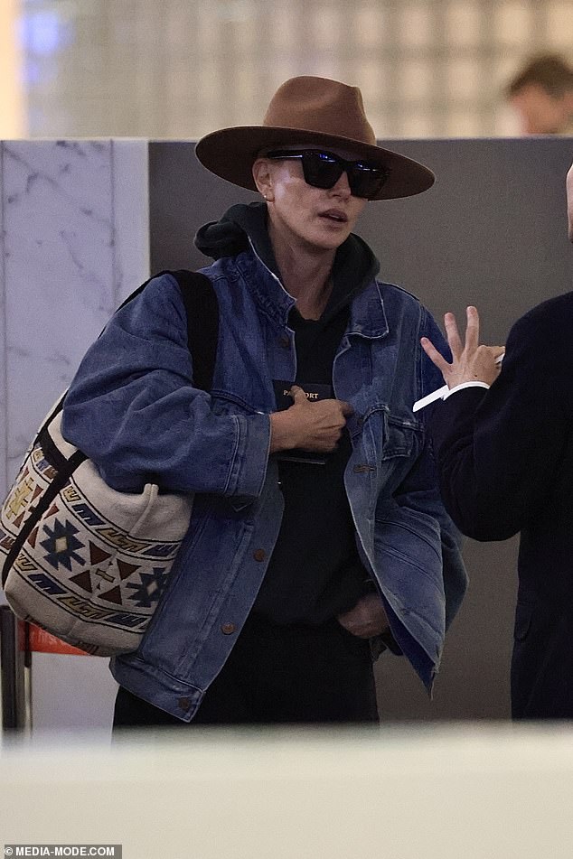 Despite looking eager to board her flight, Charlize was spotted taking time to chat with staff as she made her way through the airport