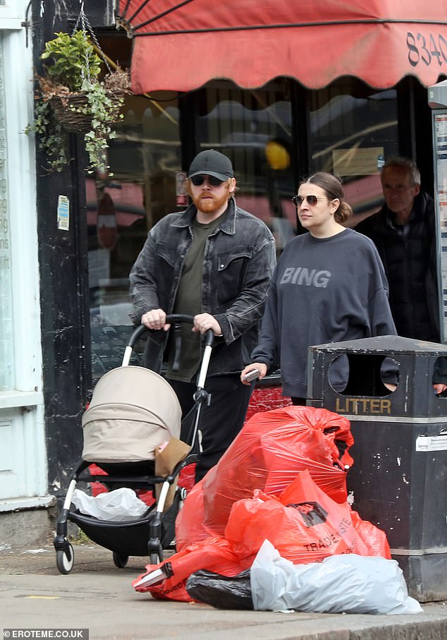 The Happy Potter star, 36, cut a casual figure as he took charge of the pram as he soaked up the sunshine alongside actress girlfriend Georgia Groome, 33