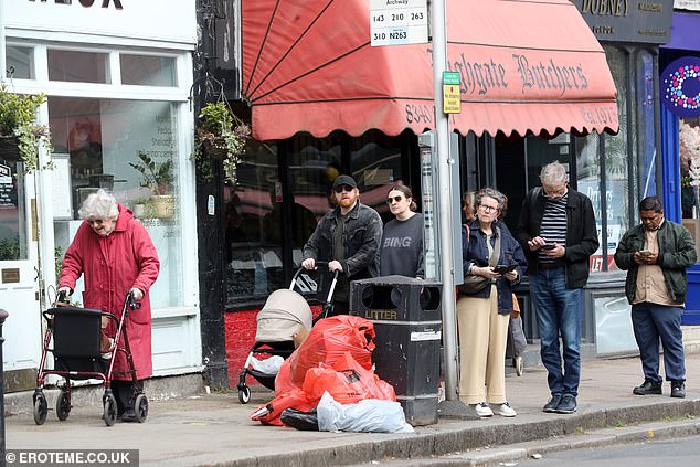 The couple, who were first reported to have secretly welcomed their second child last month, looked relaxed as they walked past a butchers shop and passersby waiting for a bus