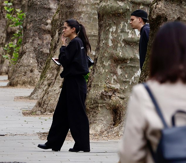 Kim swept her dark locks back in a tight ponytail