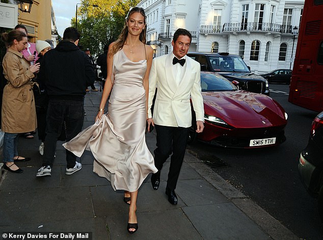 Dave and his glam girlfriend strut into the venue