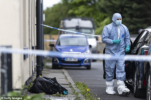 Pictured: Police forensic officers search a house on May 04, 2025 in Rochdale, England, following a counter terrorism raid