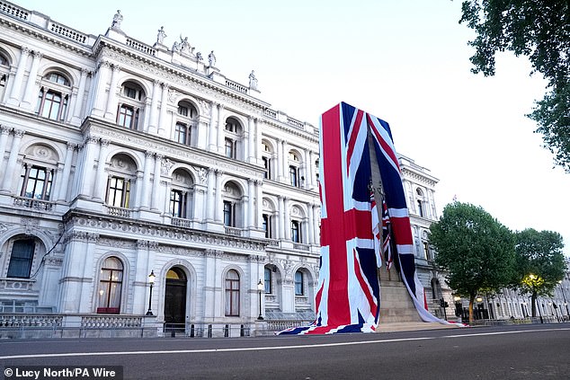 The Cenotaph on Whitehall is dressed in the Union flag ahead of a military procession