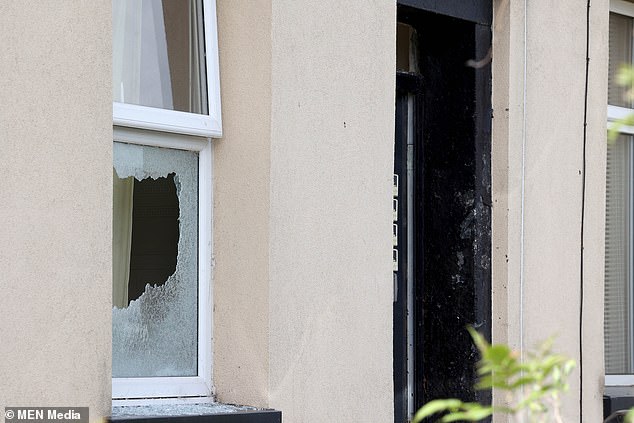 A window in the property in Rochdale that was raided appears to have been smashed. Locals reportedly heard a series of loud explosions before the suspects were detained