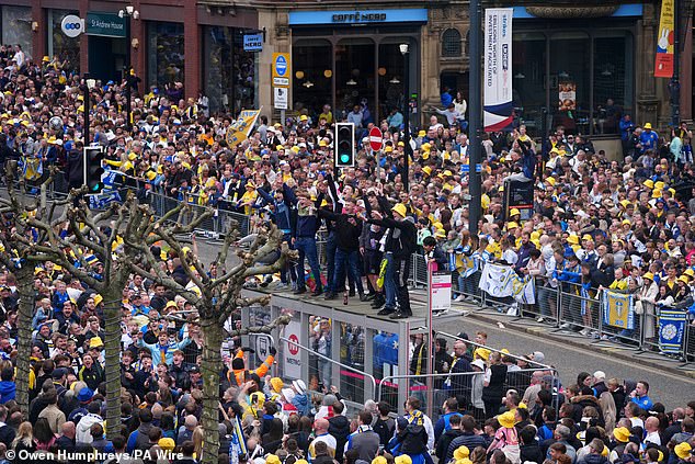 Thousands upon fans lined up in the city centre to welcome their promotion heroes on Monday
