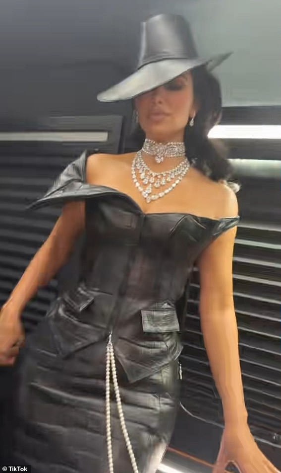 Kim decided to don some leather in a long bodycon dress with matching large fedora by Chrome Hearts