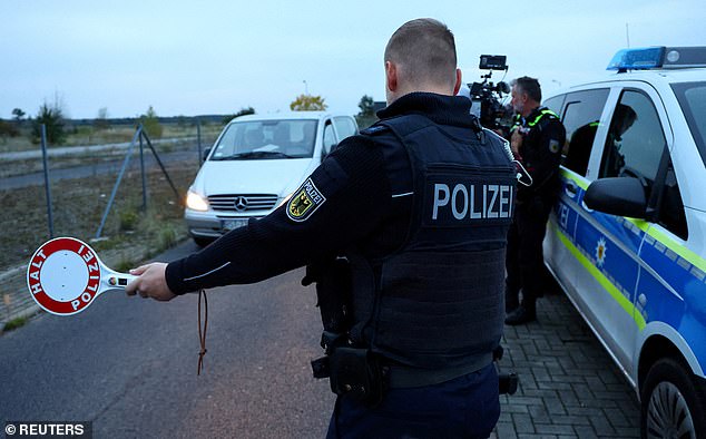 A German federal police Bundespolizei officers stops a vehicle during a patrol along the German-Polish border to prevent illegal migration near Forst, Germany, October 12, 2023