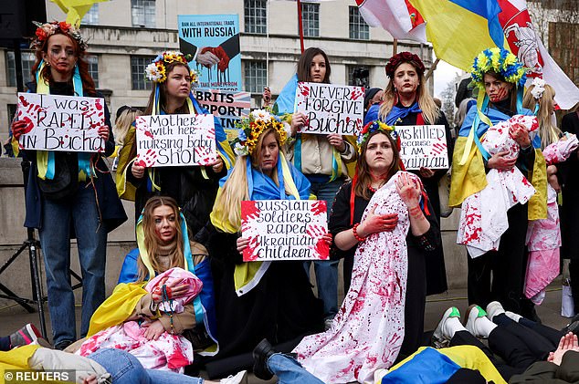 Historian Patrick Bishop says the conflict in Ukraine has taught us that 'though 80 years have passed, Russia still wages war in much the same way'. Pictured: Protestors outside Downing Street in April 2022 hold placards drawing attention to a massacre in the Ukrainian city of Bucha by Russian soldiers