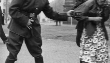 Two Russian Red Army soldiers grin with amusement as they grab at a girl in Leipzig, Germany during the postwar period