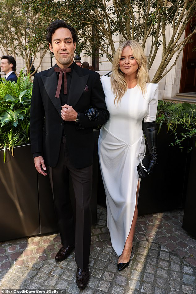 Emily, 35, wore a white dress, which boasted large shoulder pads and short sleeves, with bold leather long gloves in a nod to the eighties fashion of Rivals (pictured with co-star Alex Hassell)