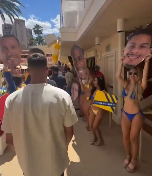 The Leeds players were hosted by models in bikinis holding placards of all of their faces