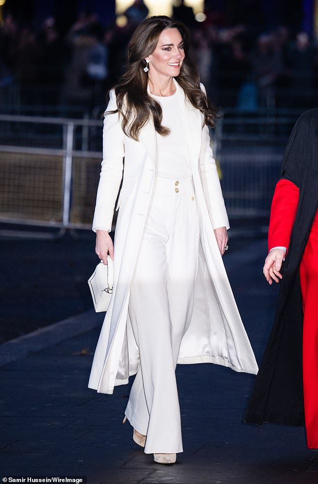 Later that same year, at her Together at Christmas carol service, she wore an elegant ivory coat by Savile Row tailor Chris Kerr over a pair of sleek high-waisted ivory trousers by Holland Cooper