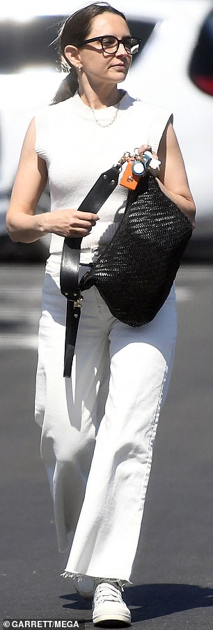 She carried her belongings in a glossy black woven bag