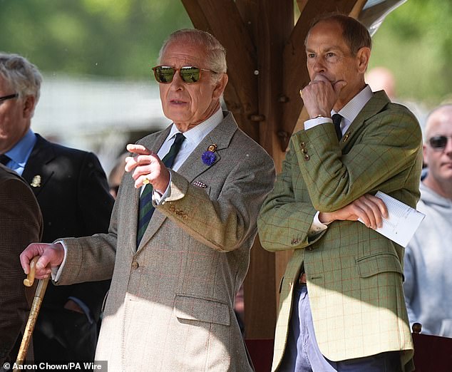 The monarch (pictured, left) was snapped watching some of the action with his youngest sibling, Prince Edward (pictured, right)