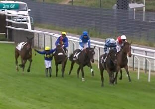 A jockey went 'horse skating' as he clung into two horses after being thrown from his own
