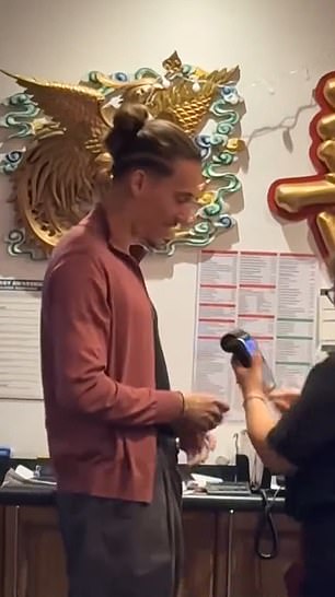 Liverpool left back can be seen paying for the order