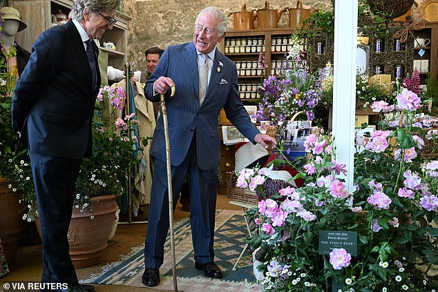 Charles carried his traditional cane as he admired a blooming bouquet of the 'King's Rose'