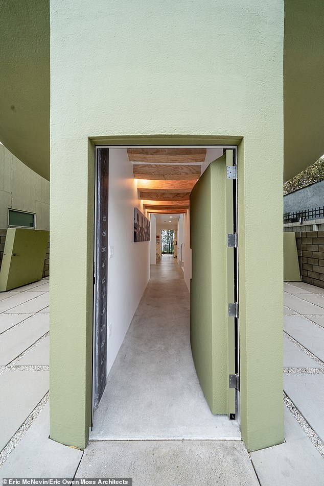 And the rooftop has an open-air deck with stunning ocean views that stretch to the horizon. The hallway leading to the roof is pictured