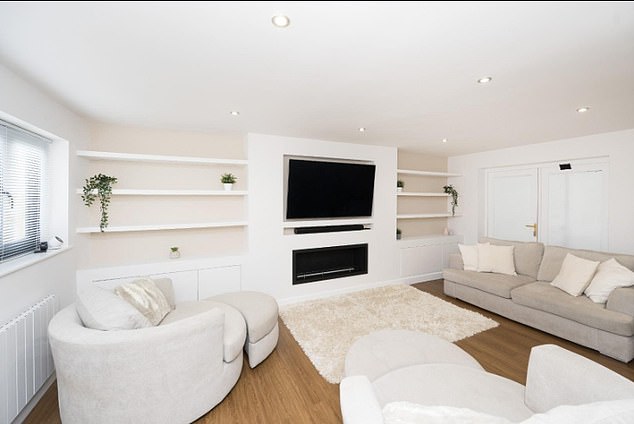 The living room is decorated in cream and white, with space for a large television