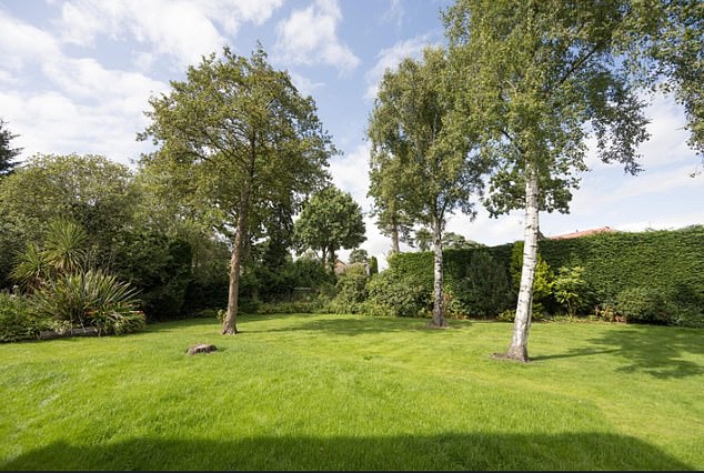There is also plenty of outdoor space, with luscious garden space comprising almost 1/3 of an acre - and a garden room to view the greenery when the weather takes a turn