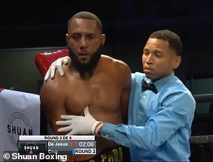 Referee Smaylin Valdez holds Julio de Jesús after action was stopped in the second round of a fight in June 2024. An upset de Jesús responded by punching Valdez