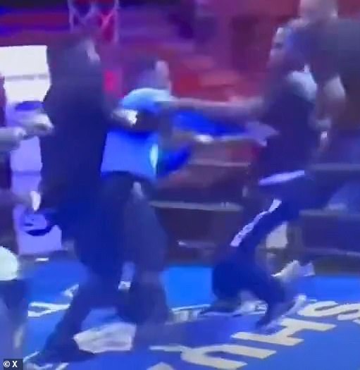 Referee Smaylin Valdez (center) is held back as a fan attacks him following at the conclusion of a boxing match in Santo Domingo, Dominican Republic on Saturday