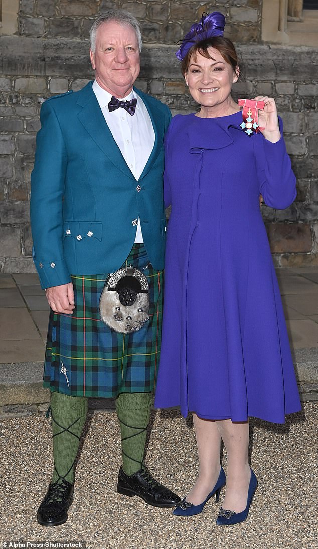 Lorraine Kelly and husband Steve Smith as she receives a CBE during an Investiture Ceremony at Windsor Castle in 2021