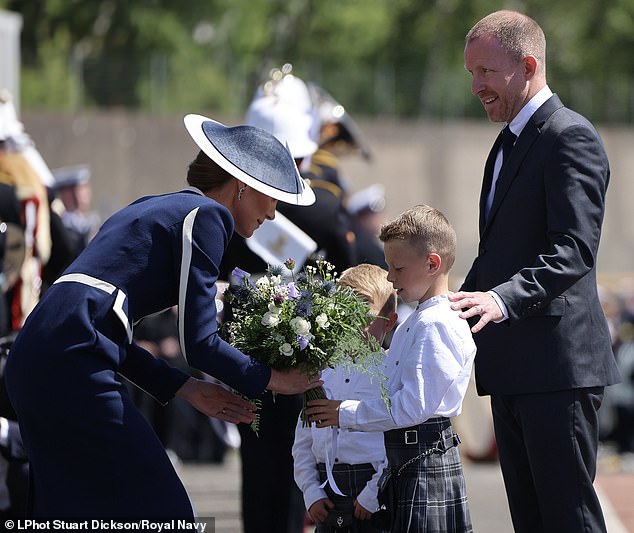 The Princess is presented flowers upon her arrival at the HMS Glasgow naming ceremony