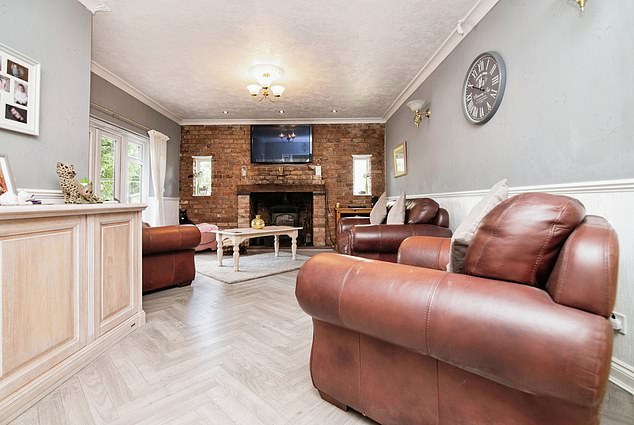 West Midlands, £600k: The living room as a sought-after brick fireplace