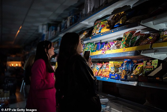 People listen to the radio through the loudspeakers of the headquarters of catalunya radioPeople outside Barcelona Sant rail station during a massive power cut