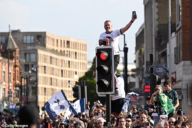 A party atmosphere consumed the route with fans waving flags and climbing on street lights