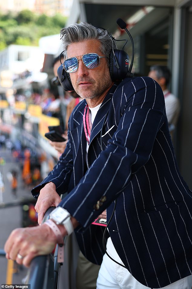 The silver fox wore a pair of white trousers with a white ribbed top beneath a smart navy blazer with matching white pin stripes