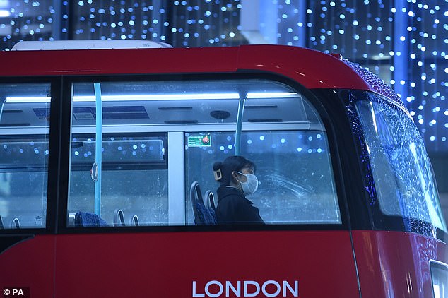 A woman alone on a bus in Oxford Street in London in December 2020 at the height of the Covid-19 pandemic