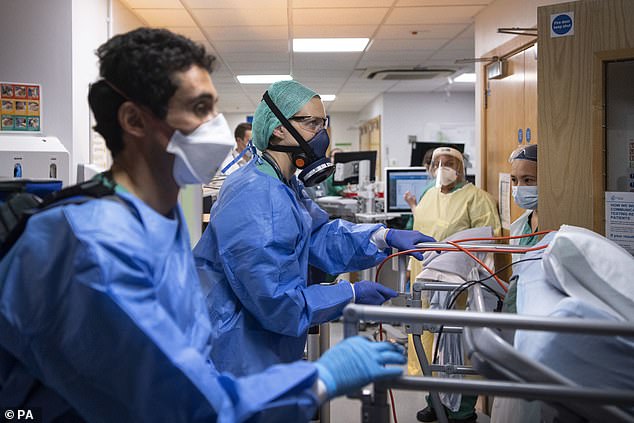 Medical staff transfer a patient from the Acute Dependency Unit to the ICU (Intensive Care Unit) at St George's Hospital in Tooting, south-west London