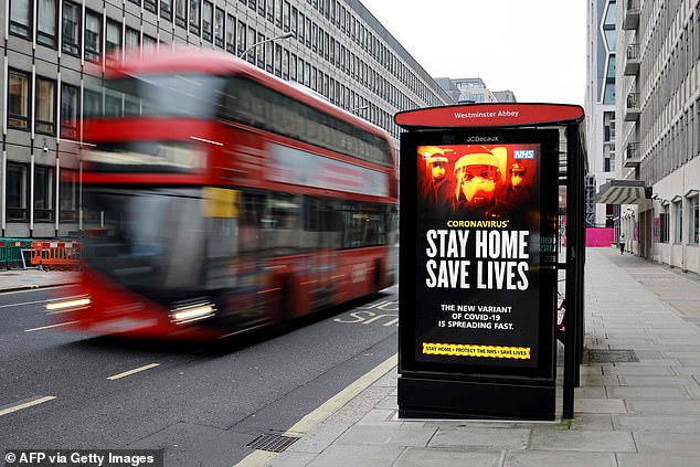 A digital display at a bus station warns pedestrians of the new strain of coronavirus in central London on January 8, 2021