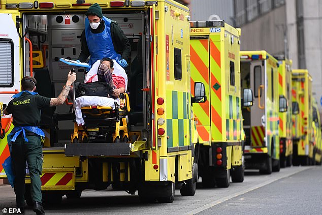 NHS ambulances staff bring a patient into the Royal London hospital in London, Britain, 19 January 2021