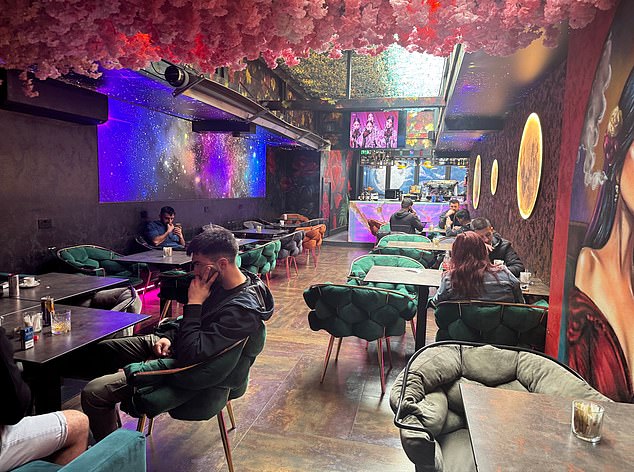 Inside the bar and grill, customers were seen to be smoking cigarettes as bar staff walked past