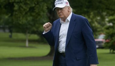 President Donald Trump acknowledges reporters as he disembarks Marine One upon arrival on the South Lawn of the White House